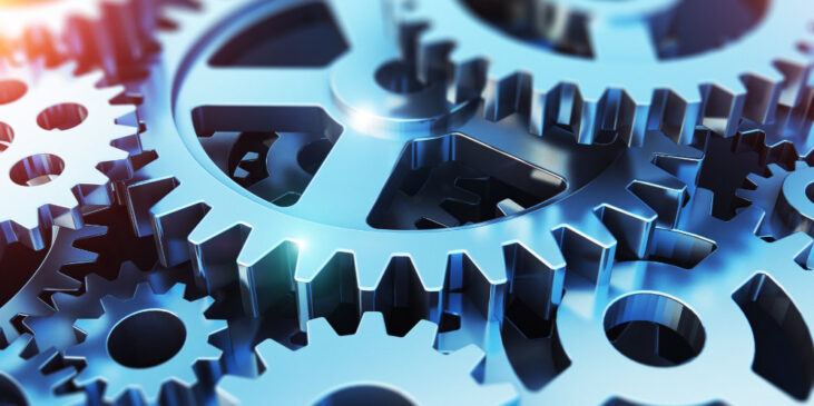 Creative abstract 3D render illustration of the macro view of the set of metal shiny gears or cogwheels with selective focus effect