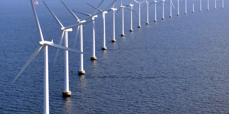 A row of wind turbines in a body of water