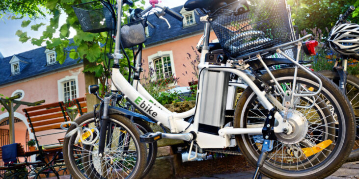 An image of 2 e-bikes parked in front of a building