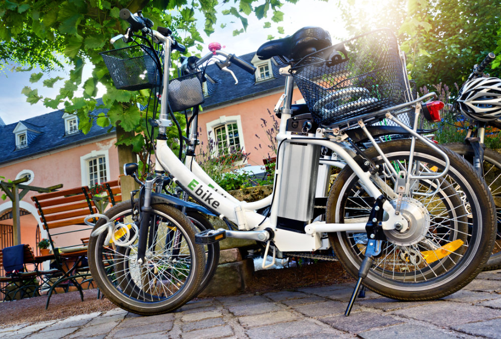 An image of 2 e-bikes parked in front of a building